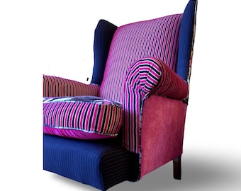 May include: A pink and black striped wingback armchair with a blue and black striped base. The chair has a patchwork design with different fabrics.