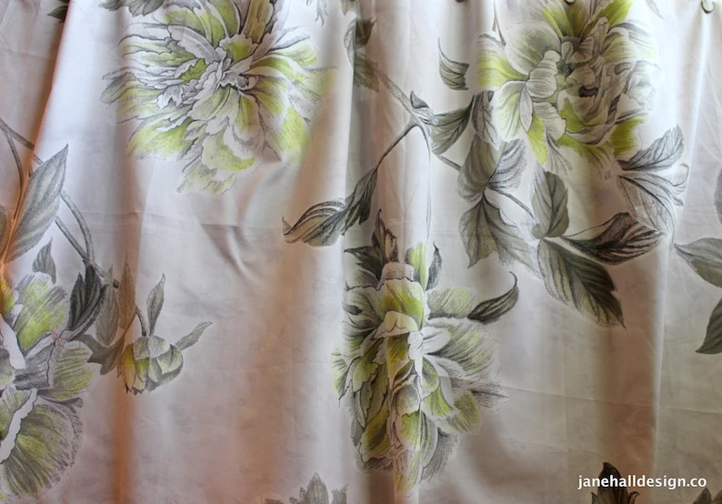 May include: White fabric with a floral pattern of green and gray peonies. The fabric has a subtle sheen and a soft texture.
