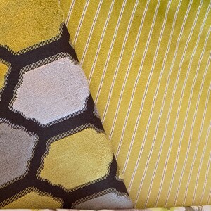 May include: Two fabric swatches, one with a honeycomb pattern in shades of yellow and gray, and the other with a striped pattern in yellow and white.
