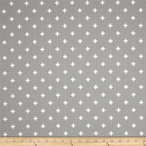 May include: A gray fabric with a white plus sign pattern. The fabric is a repeating pattern of white plus signs on a gray background.