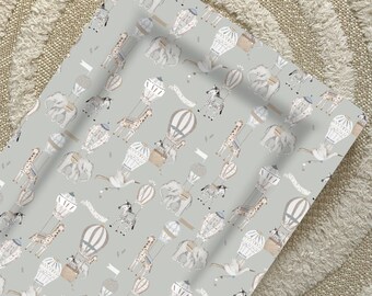 May include: A light gray background with a repeating pattern of hot air balloons, zebras, giraffes, and elephants. The hot air balloons are decorated with stripes and have a brown basket. The animals are all facing the right side of the image.