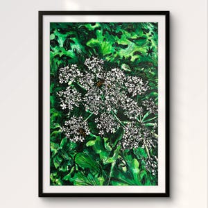 May include: A framed botanical art print featuring a detailed depiction of white wildflowers and green foliage. The artwork includes a black frame and is set against a white background. The painting style is illustrative with visible brushstrokes.