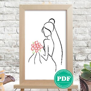 Pode incluir: Um desenho a preto e branco de uma noiva segurando um ramo de flores cor-de-rosa. A noiva está usando um véu e tem o cabelo puxado para trás. O desenho está emoldurado numa moldura de madeira e está sentado num cavalete de madeira.