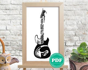 Pode incluir: Padrão de ponto cruz preto e branco de uma guitarra elétrica em uma moldura de madeira com um botão de download PDF verde que diz "Fluffy Fuzzy Cross Stitch PDF".