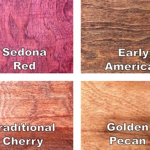 May include: A close-up of four wood stain samples. The stains are labeled "Sedona Red", "Early American", "Traditional Cherry", and "Golden Pecan". The wood grain is visible in each sample, showcasing the different colors and textures.