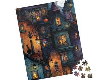 May include: A colorful Halloween-themed jigsaw puzzle depicting a spooky village scene. The illustration features houses with lit windows, pumpkins, and a full moon. A few puzzle pieces are separate from the main image.