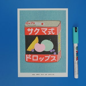 A risograph print of a tin can of sakuma drops