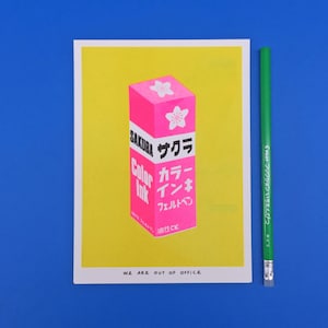 A risograph print of a very bright Japanese package of pink sakura ink