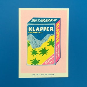 May include: A pink and yellow illustration of a coconut oil tin with the text "100% Organic Klapper Coconut Oil" and "100% Organic Klapper Coconut Oil" on the front. The text "We Are Out Of Office" is at the bottom of the image.