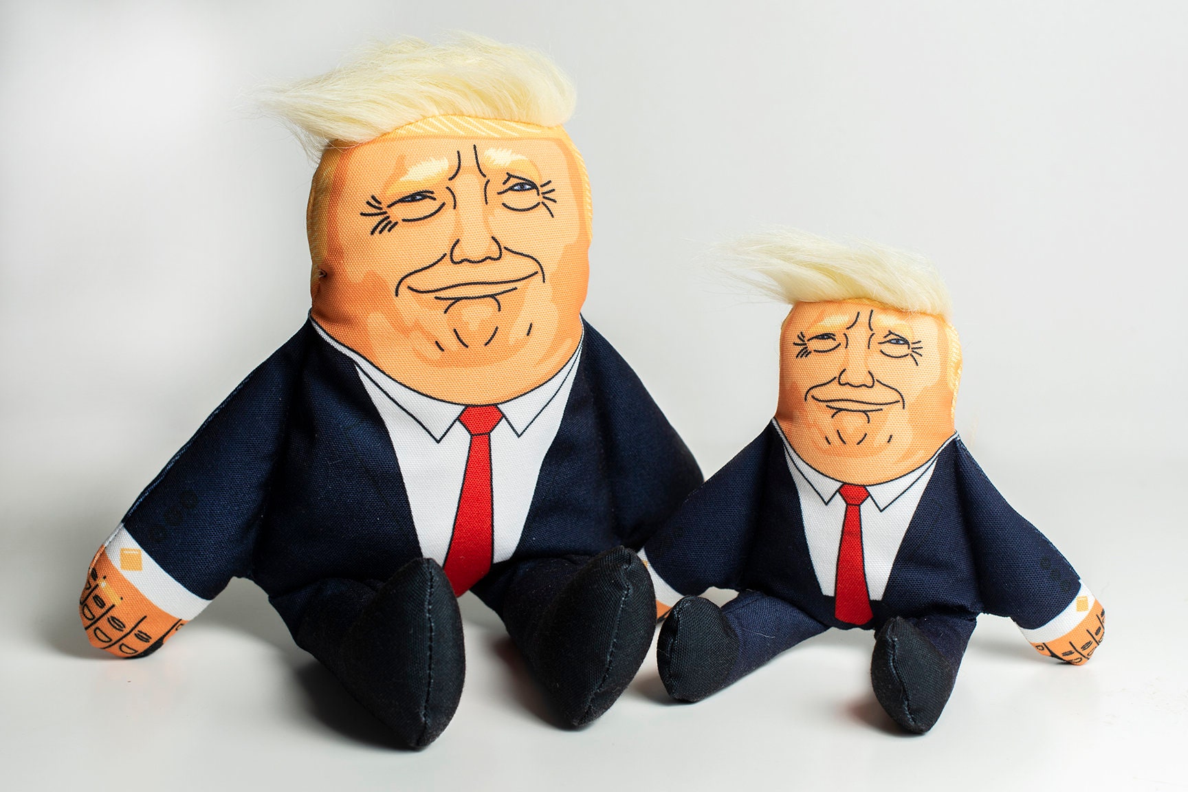 Plush squeaky Trump parody dog toy with orange hair and suit
