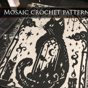 May include: A black and white crochet blanket featuring a mosaic pattern of a cat sitting before a window with a crescent moon. The design includes stars, candles, and clouds, with the text MOSAIC CROCHET PATTERN and Loops Obscure designs.