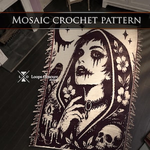 May include: A rectangular woven throw blanket featuring a black and white mosaic crochet pattern of a person in a hooded cloak, a skull, candles, a bird, and flowers. The text "MOSAIC CROCHET PATTERN" and "Loops Obscure designs" is visible.