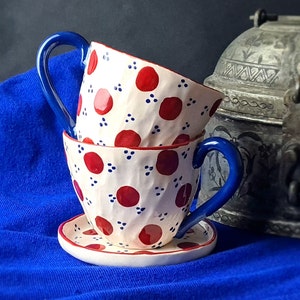Two handmade pottery cups with saucers for a special price. Ceramic mug set with spring flowers is a unique gift for coffee and tea lovers.
