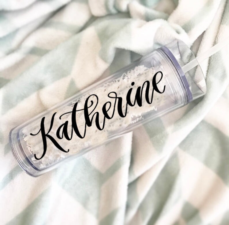 May include: A clear plastic tumbler with a black cursive inscription that reads "Katherine".