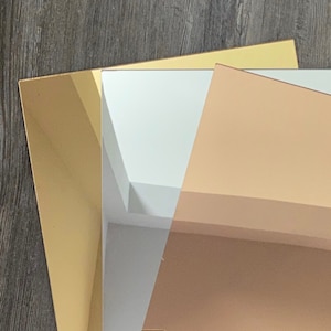May include: Three sheets of mirrored acrylic in gold, silver and rose gold.