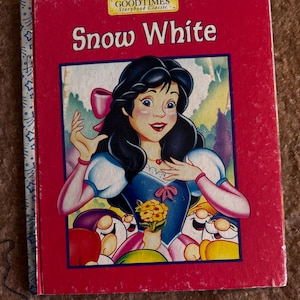 May include: A vintage "Snow White" storybook with a red cover. The cover features an illustration of Snow White in a blue dress, holding flowers, with the seven dwarfs. The book is a "Goodtimes Storybook Classic".