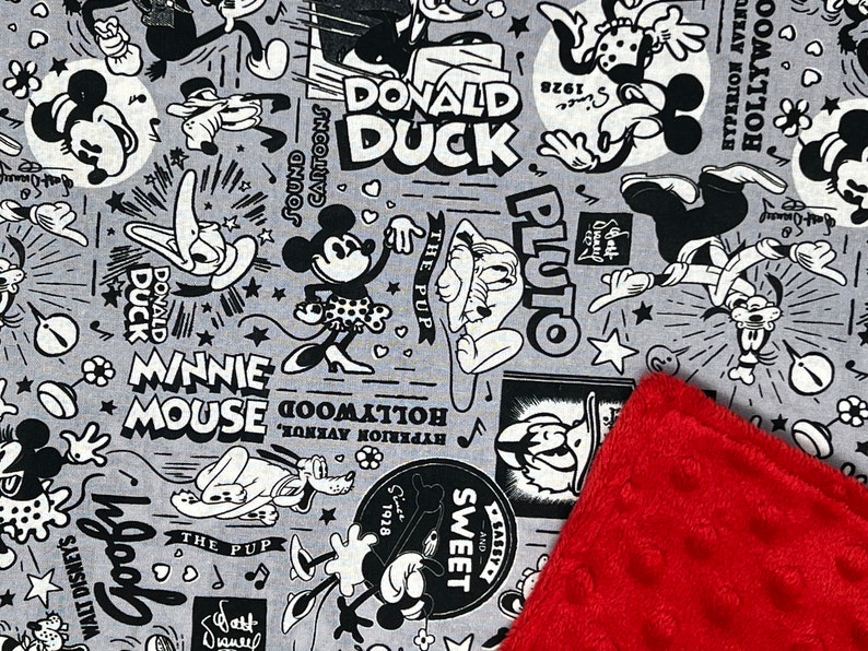 Peut inclure: Tissu gris avec des personnages de dessins anim&eacute;s en noir et blanc, tels que Mickey Mouse, Donald Duck et Pluto. Un coin rouge textur&eacute; est visible.