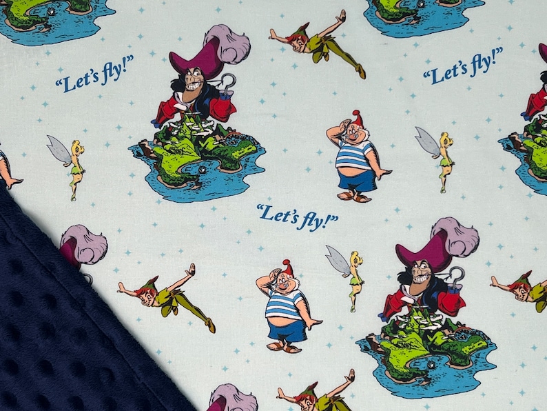May include: A blue and white fabric with a repeating pattern of Peter Pan, Captain Hook, Tinkerbell, and the phrase "Let's fly!"