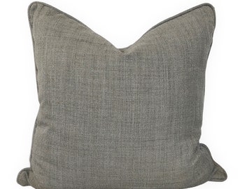May include: A gray throw pillow with a textured fabric. The pillow has a simple, rectangular shape with slightly rounded corners.