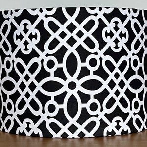 May include: Black and white lampshade with a geometric pattern. The pattern features interlocking circles and lines.