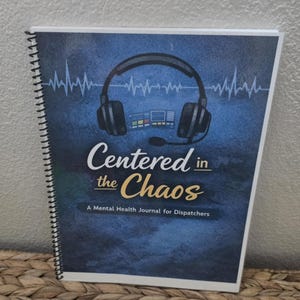 May include: A spiral-bound journal titled "Centered in the Chaos: A Mental Health Journal for Dispatchers." The cover features a headset graphic, sound wave lines, and a blue and white color scheme.