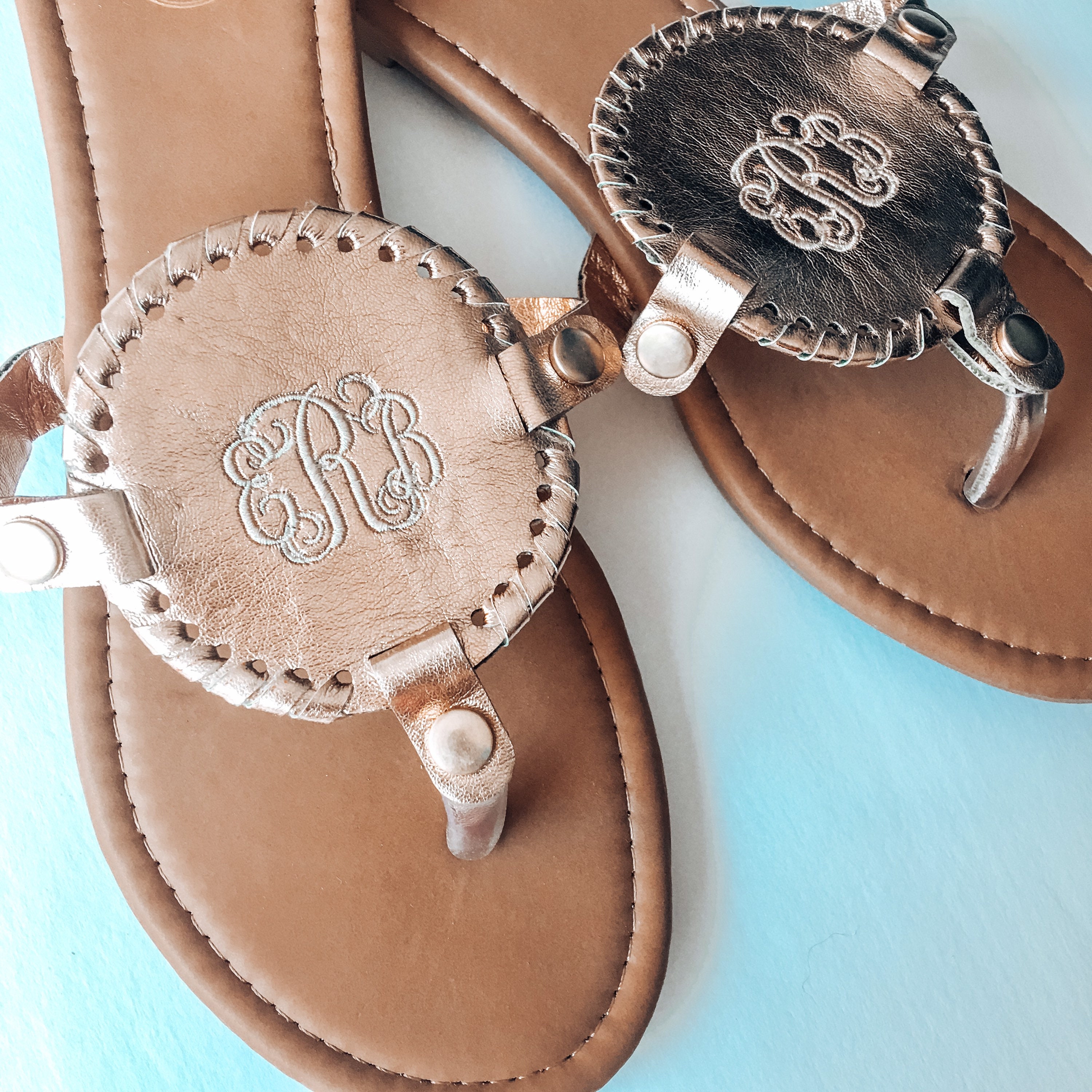 flip flops with gold medallion