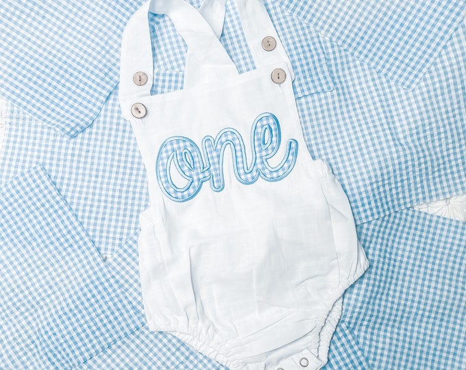 First birthday outfit for baby boy - white bubble romper with blue gingham embroidered “one” appliqué