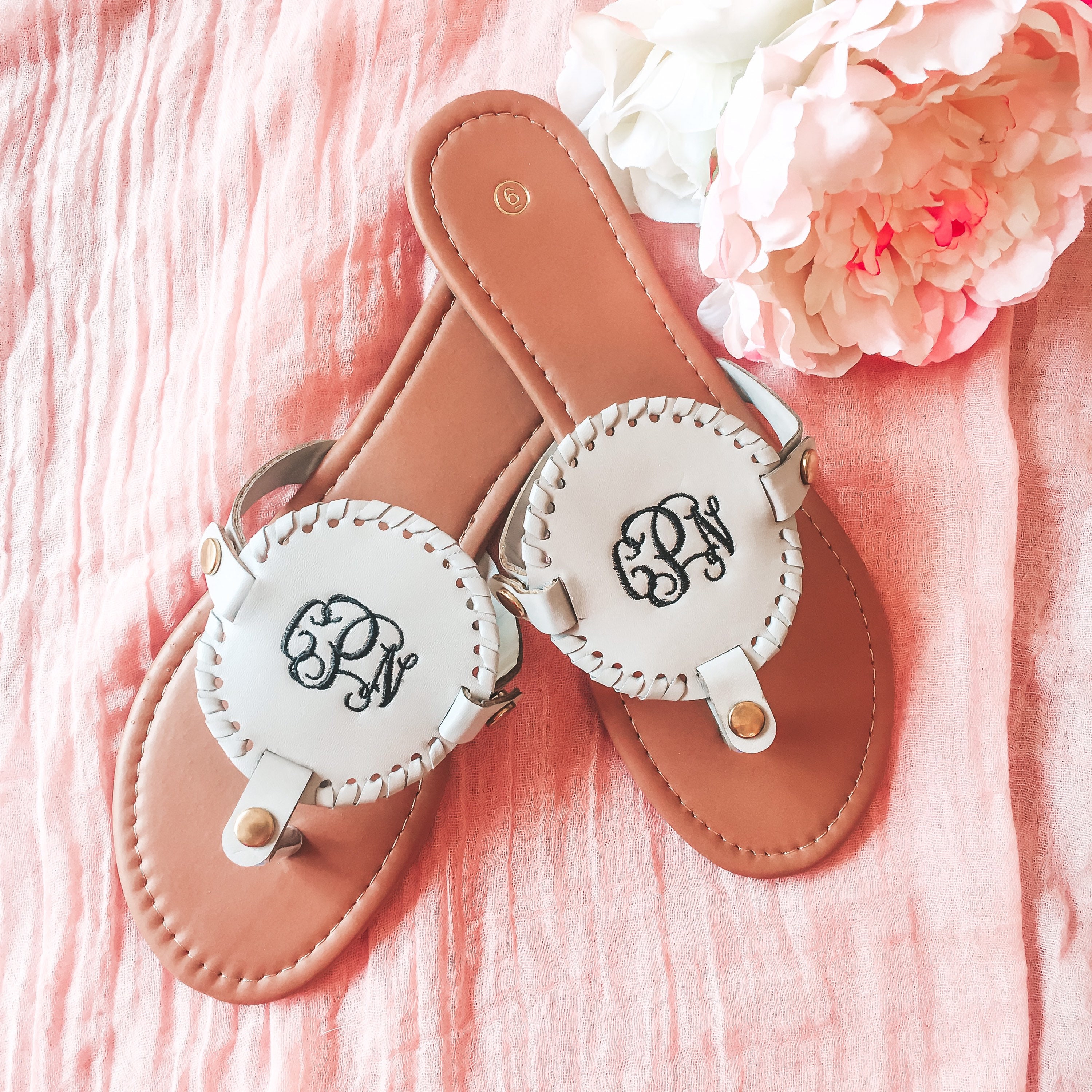 flip flops with gold medallion