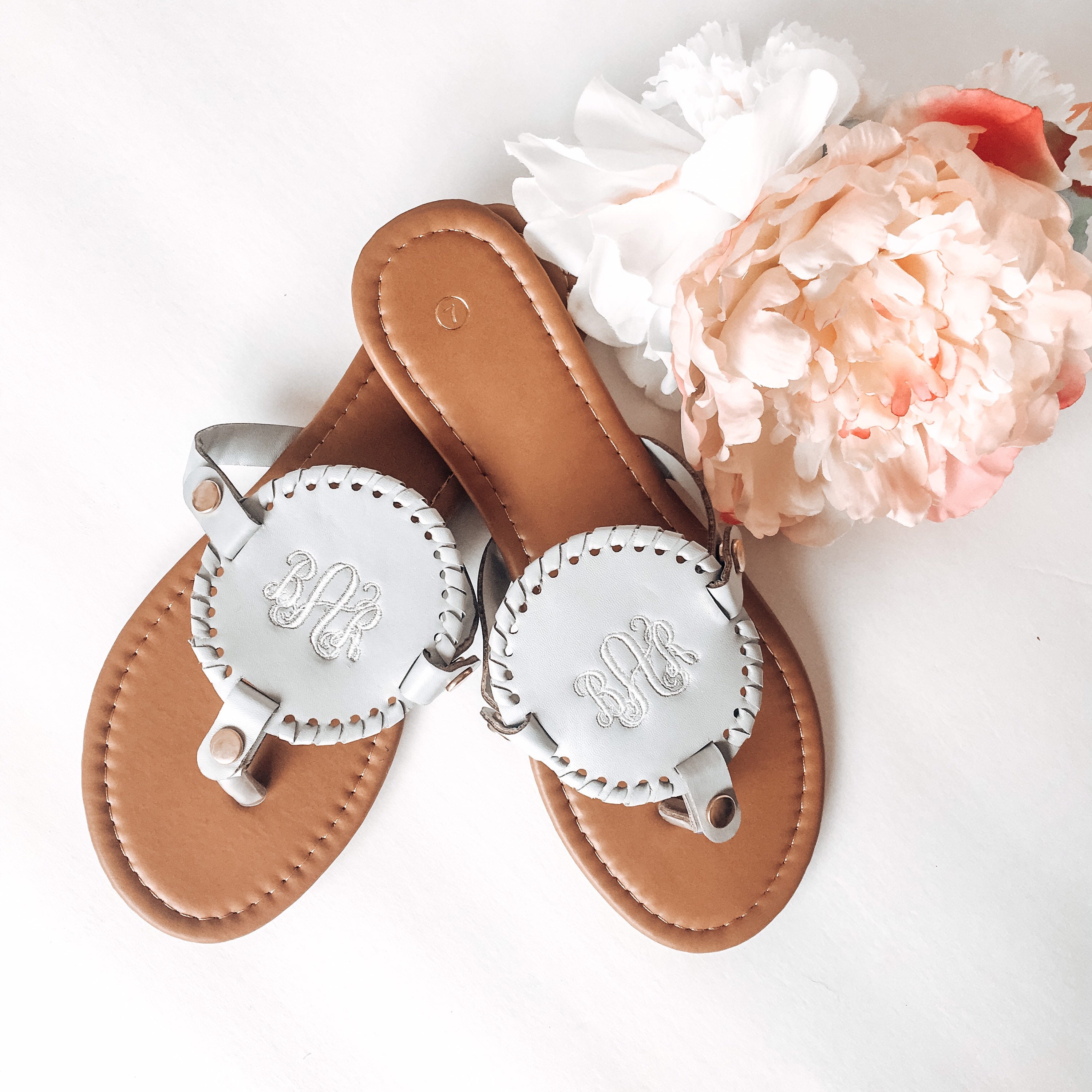 flip flops with gold medallion