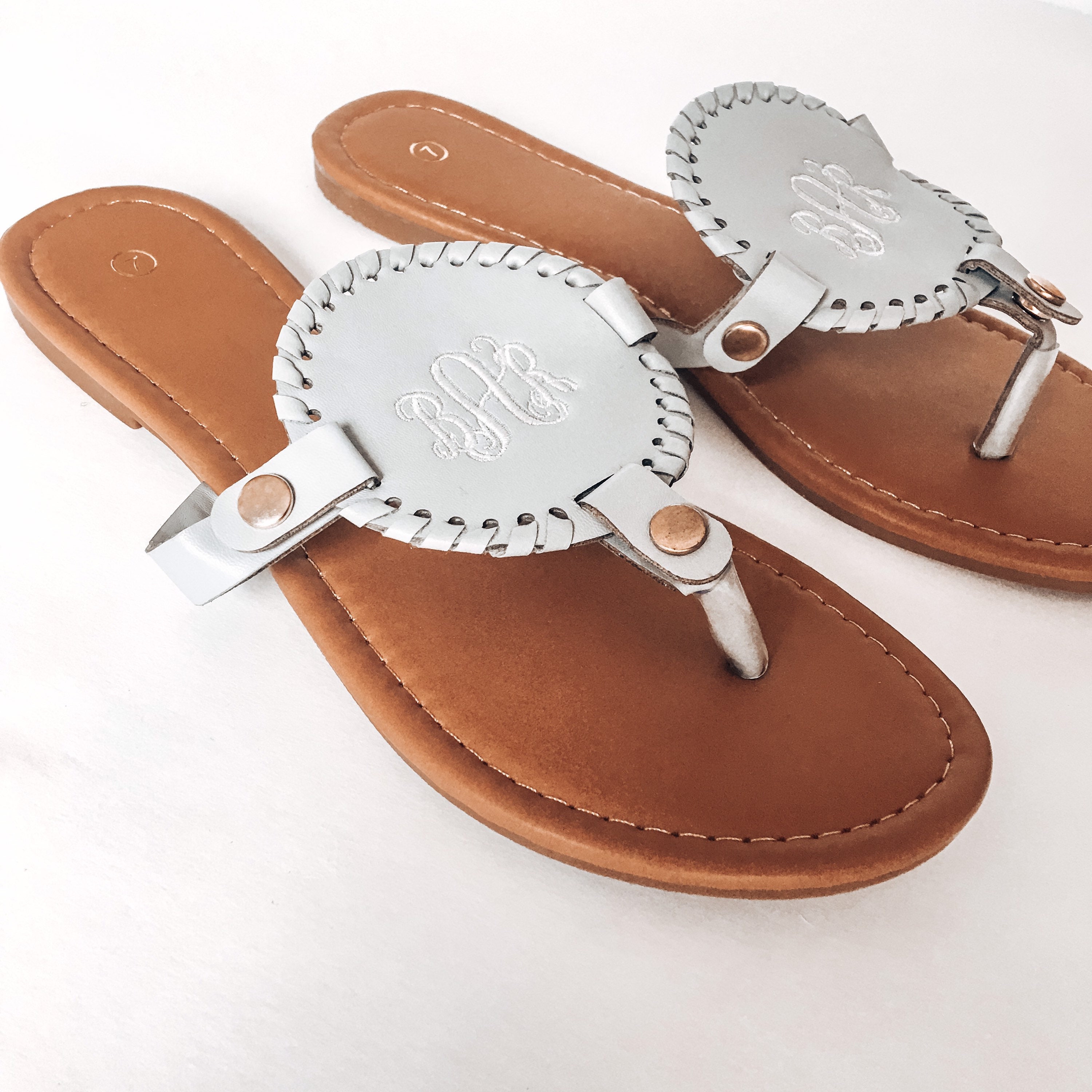 flip flops with gold medallion