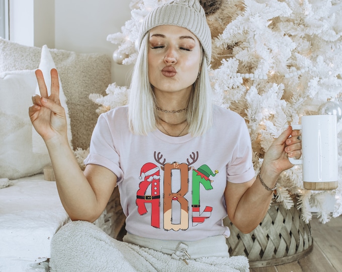 Fun Monogram Christmas Tshirt for Women - Monogram initials have a santa outfit reindeer graphic and elf outfit on the letters