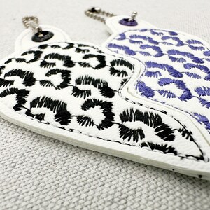 Leopard print Split Heart Eyelet and Key Fob Snap Tab keychain in the shown on fabric Instant Download By Fonts Heaven Embroidery Format PES HUS DST JEF EXP VP3 XXX EXP