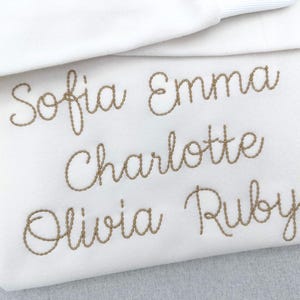 May include: A set of three ceramic mugs with a speckled, matte finish. The mugs are in shades of cream, light gray, and dark gray. Each mug has a simple, minimalist design and a rounded handle.