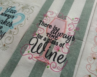 May include: Embroidered kitchen towel with a green and white striped background. The towel features a pink wine glass with the text "There is always time for a glass of wine".