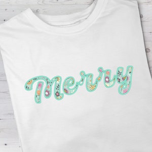May include: White t-shirt with the word "Merry" written in a cursive font. The letters are filled with a floral pattern in shades of pink, green, and blue, outlined in turquoise.