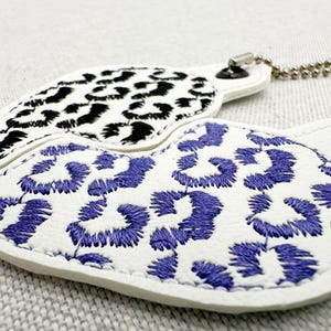 Finished embroidery sample of Leopard print Split Heart Eyelet and Key Fob Snap Tab keychain in the hoop machine Instant Download By Fonts Heaven Embroidery Format PES HUS DST JEF EXP VP3 XXX EXP