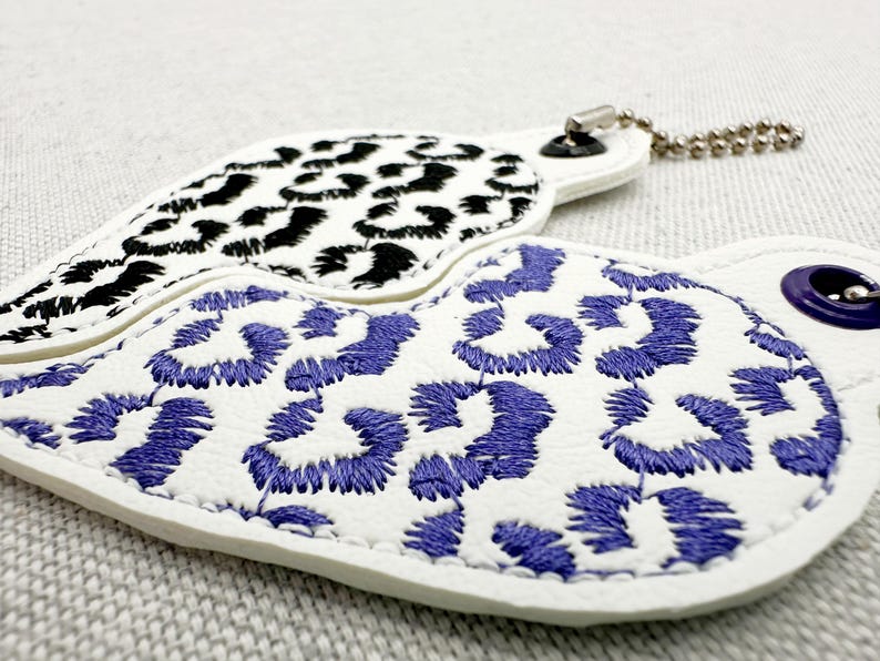 Finished embroidery sample of Leopard print Split Heart Eyelet and Key Fob Snap Tab keychain in the hoop machine Instant Download By Fonts Heaven Embroidery Format PES HUS DST JEF EXP VP3 XXX EXP