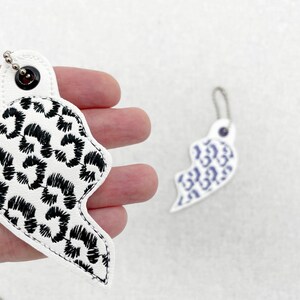 Product detail view of Leopard print Split Heart Eyelet and Key Fob Snap Tab keychain in the hoop machine embroidery designs ITH Valentines Instant Download By Fonts Heaven Embroidery Format PES HUS DST JEF EXP VP3 XXX EXP