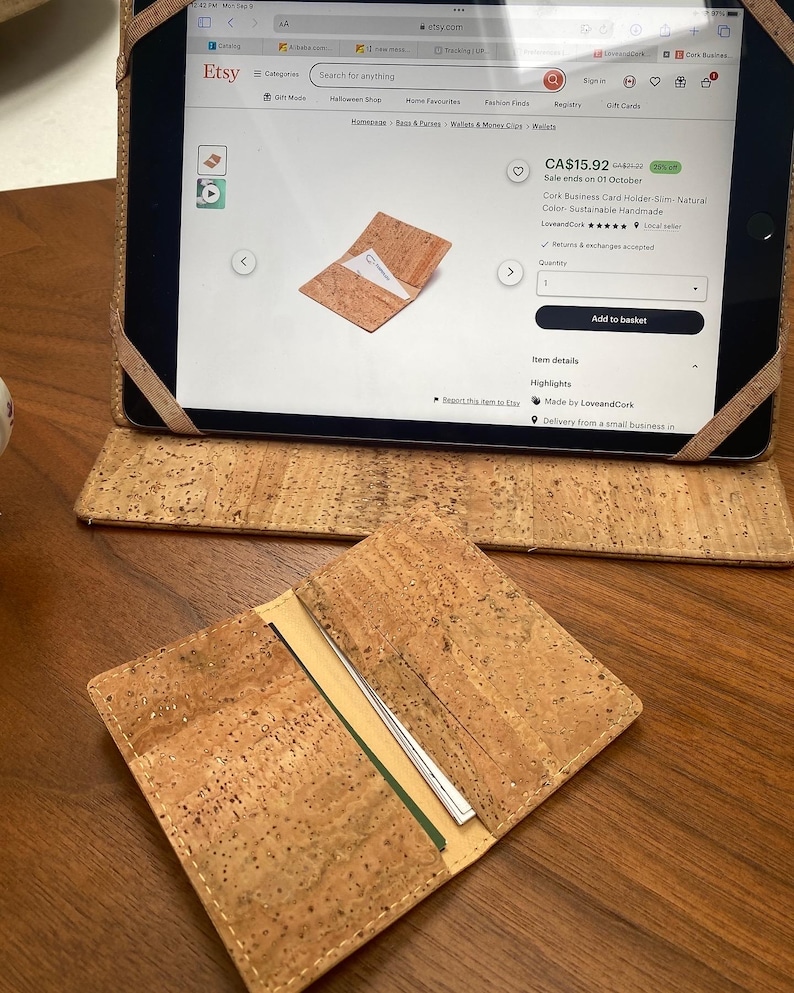 May include: A cork business card holder with a slim design. The card holder is made of natural cork and is handmade. The product is sustainable and is available for purchase on Etsy.