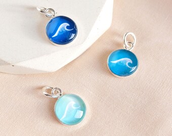 Sterling silver wave charm. Beach jewellery, ideal surfer gift or gift for wild swimmers . Wave design on ocean themed colours.