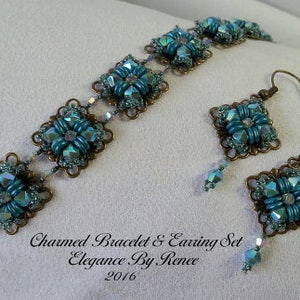 May include: A turquoise and bronze bracelet and earring set with a square design. The bracelet and earrings feature a repeating pattern of turquoise and clear crystals. The set is labeled "Charmed Bracelet & Earring Set Elegance By Renee 2016".