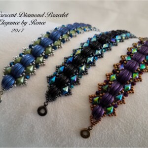 May include: Three beaded bracelets with a chevron pattern. The bracelets are made with blue, green, black, purple, and gold beads. The bracelets are called "Sleekly Crescent Diamond Bracelet Elegance by Renee 2017".