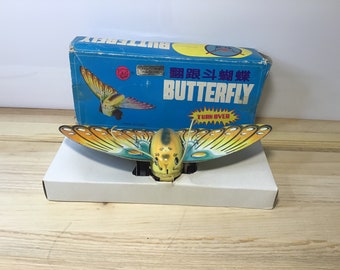 Tin Butterfly Turn Over Tin Toy