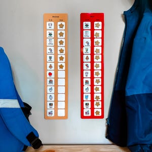 May include: Two colorful chore charts hang on a wall. One is orange, the other red. Each chart has illustrated icons for tasks, star-shaped reward markers, and the name "Bonnie" at the top. A blue jacket hangs on the right.