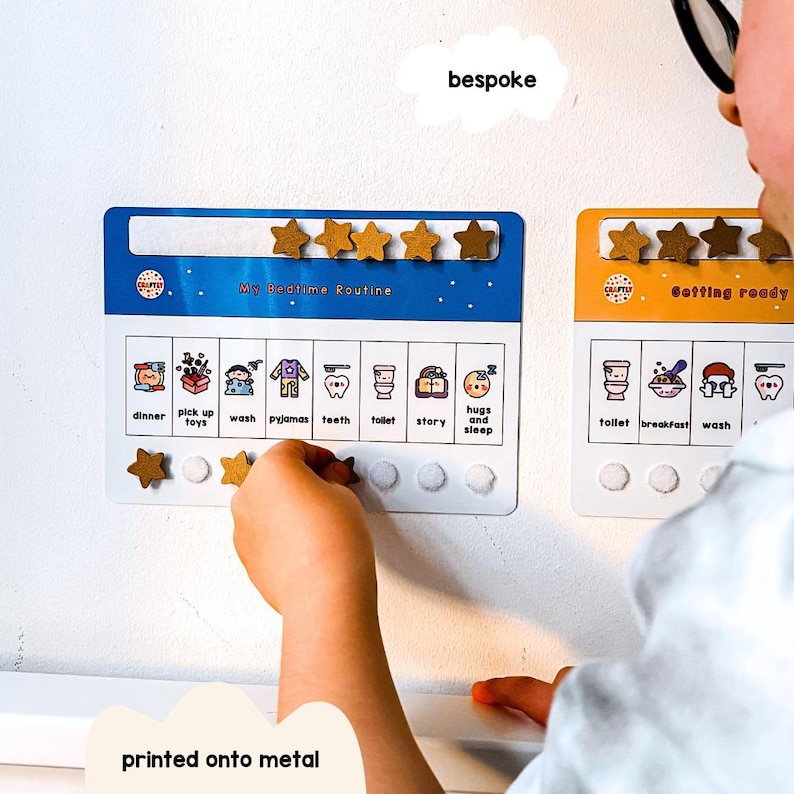 May include: Two magnetic chore charts, one blue and one orange, with star-shaped magnets. The blue chart reads "My Bedtime Routine" and the orange chart reads "Getting Ready". Each chart has illustrated icons for daily tasks.