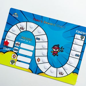 May include: A blue and yellow reward chart with a superhero theme. The chart has a path with white circles to place stickers on. The chart says "Theo's Reward Chart" and has a superhero character in the middle. The chart has a start and finish line.