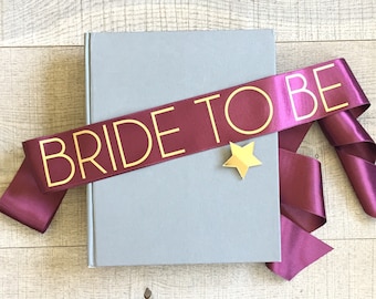 Bride to be sash, bachelorette sash, burgundy and gold sash, bachelorette sash with gold star pin, hen sash, hen party sash, bridal sash