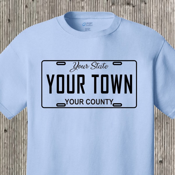 Your town (community, city, etc) license plate car tag T shirt also featuring your state and county - any place!  Many colors to choose from