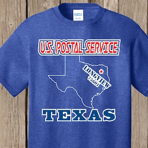 May include: Blue t-shirt with a white outline of the state of Texas and the text "U.S. Postal Service" and "Texas". The city of Longview, Texas is highlighted with a red star and the zip code 75601.