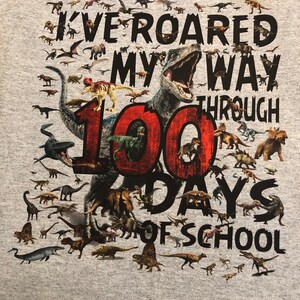 100th Day of School T Shirt 100 dinosaurs I've roared my way through 100 days of school Ships very quickly Now in gray, white, sand,red Athletic Heather